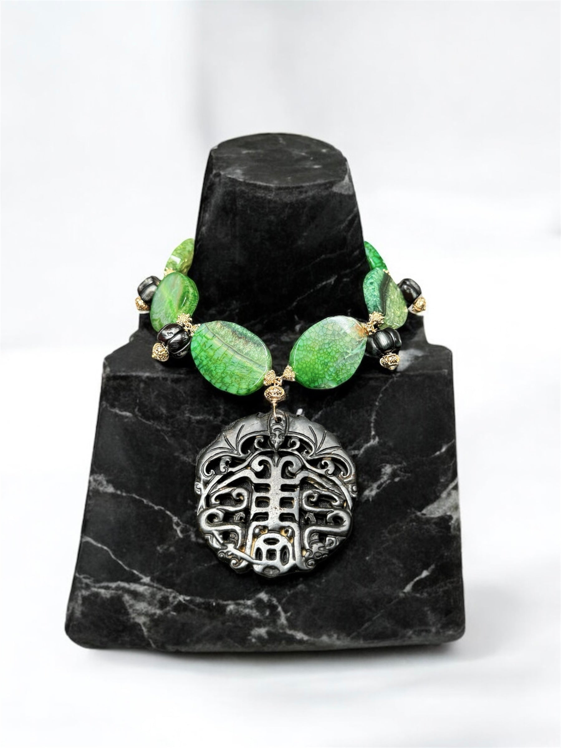 Handcrafted green gemstone artisan agate statement necklace with a carved black jade pendant 